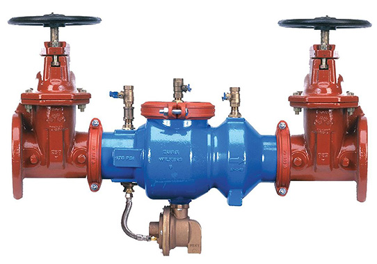 Blue and red industrial backflow prevention assembly with manual valves and test ports.