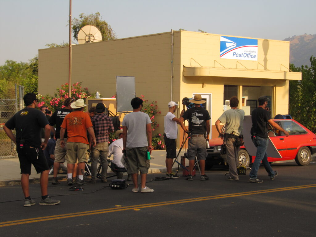 Film crew working outside the United States Post Office building.