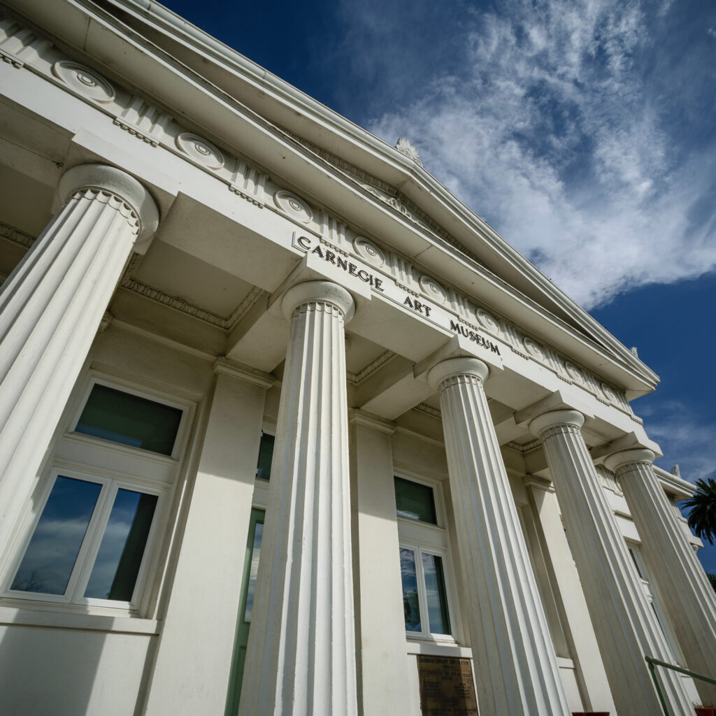 Detailed upward view of the building’s Doric columns at the Carnegie Art Museum.