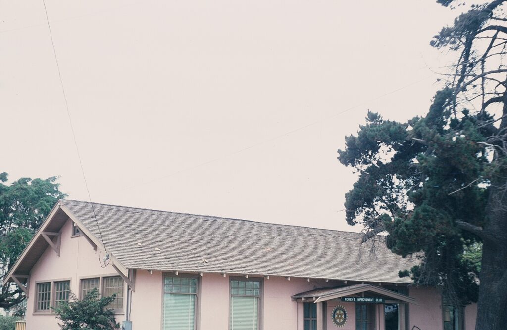 Women's Improvement Club building with a 1978 sign and trees nearby