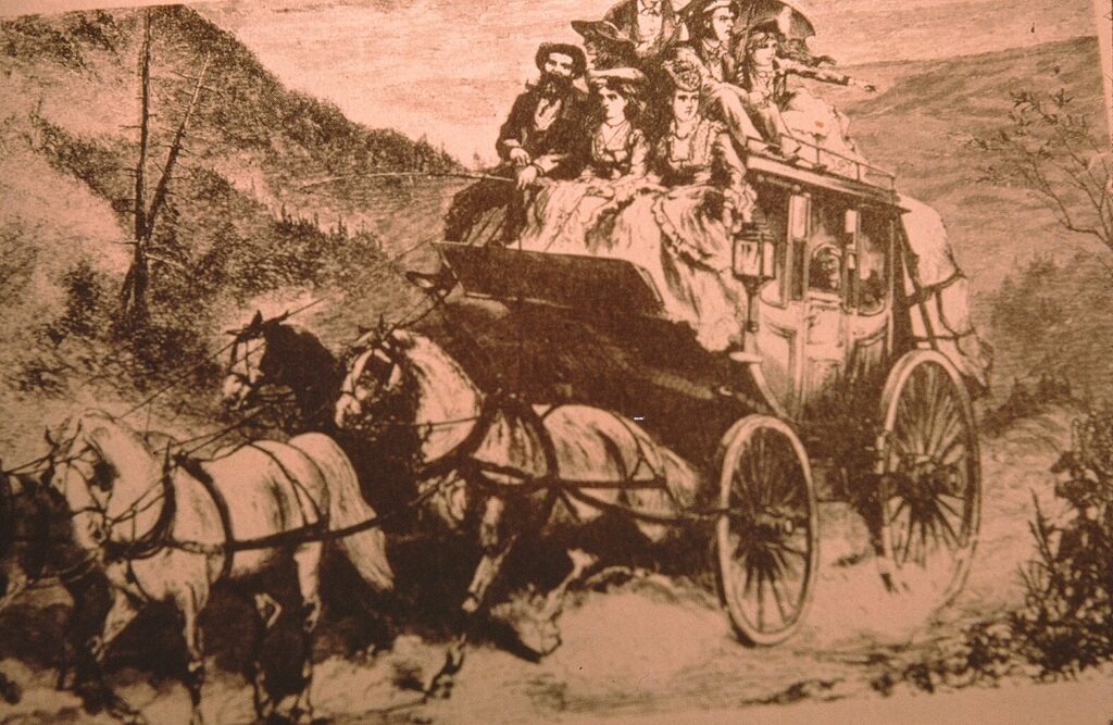Historical stagecoach with passengers, drawn by a team of horses.