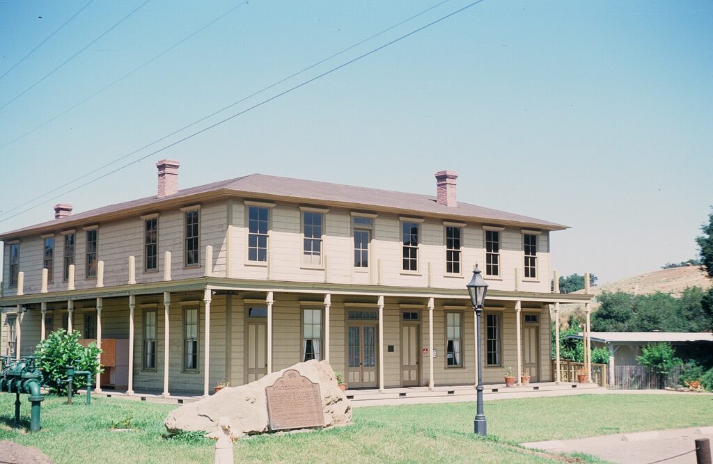 Front view of Stagecoach Inn with historical marker and surrounding greenery, taken in 1978.