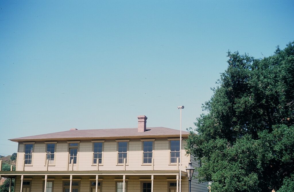Upper section of Stagecoach Inn with visible roof, windows, and surrounding trees, taken in 1978.
