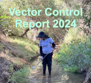 A person in protective gear holding a white bucket while working in a field of tall, weedy vegetation. Text overlay reads "Vector Control Report 2024".