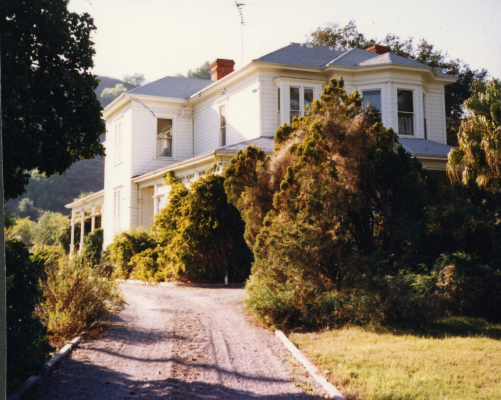 Historic two-story house with a driveway, surrounded by trees, Hardison House, 1985.