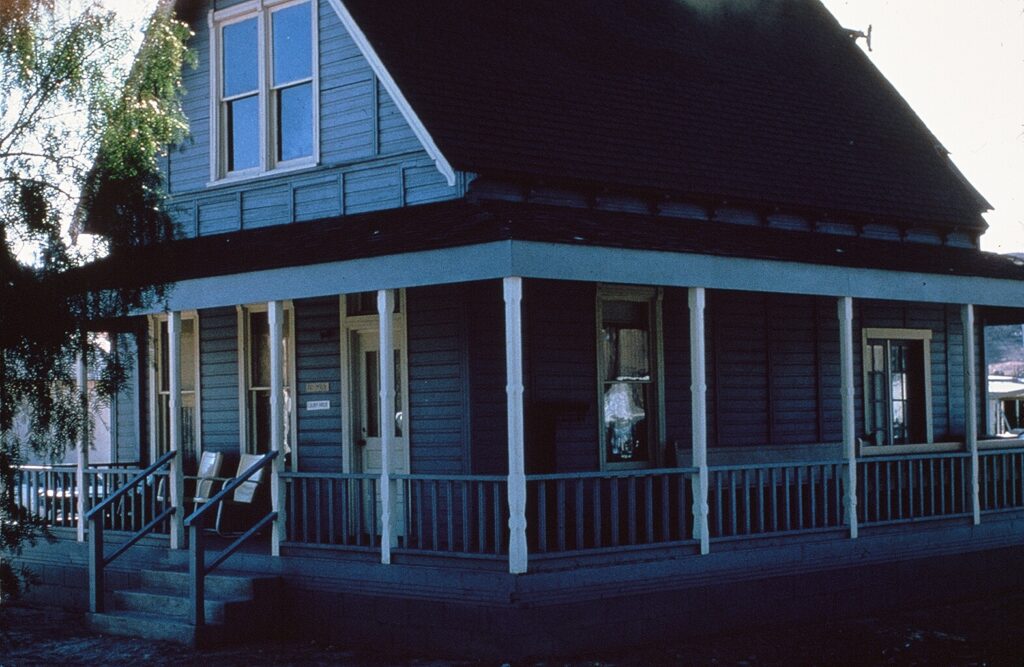 Side view of Haigh/Talley Colony House with wraparound porch, taken in 1978.