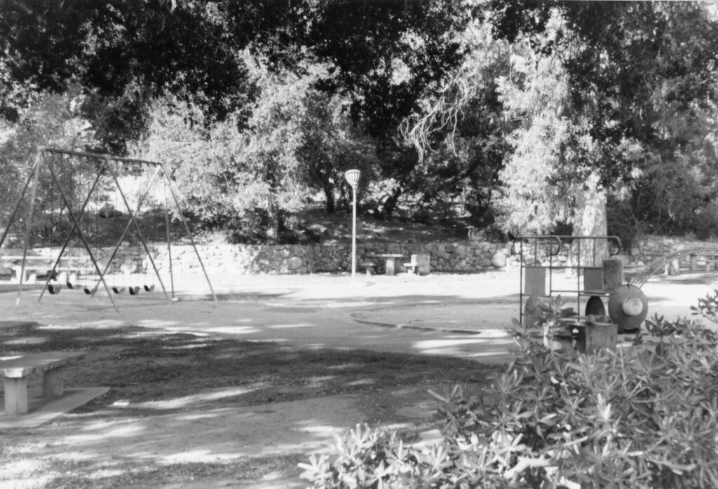 Playground area with swings and trees at Mill Park, 1985.