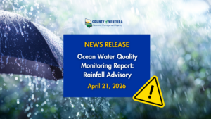 Ventura County Resource Management Agency news release graphic announcing an Ocean Water Quality Monitoring Report and Rainfall Advisory dated April 21, 2026. The graphic features a close-up photograph of heavy rainfall with a dark umbrella in the foreground, overlaid with a blue announcement box and a yellow caution triangle warning symbol.