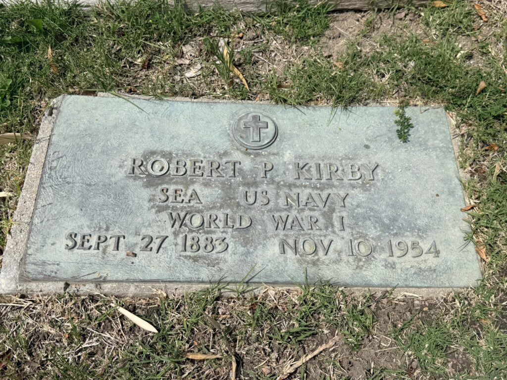 Bronze headstone in Pioneer Cemetery for Robert P Kirby, a US Navy veteran of World War I, with visible text "SEA US NAVY WORLD WAR I", dated September 27, 1883 – November 10, 1954, and a cross emblem.