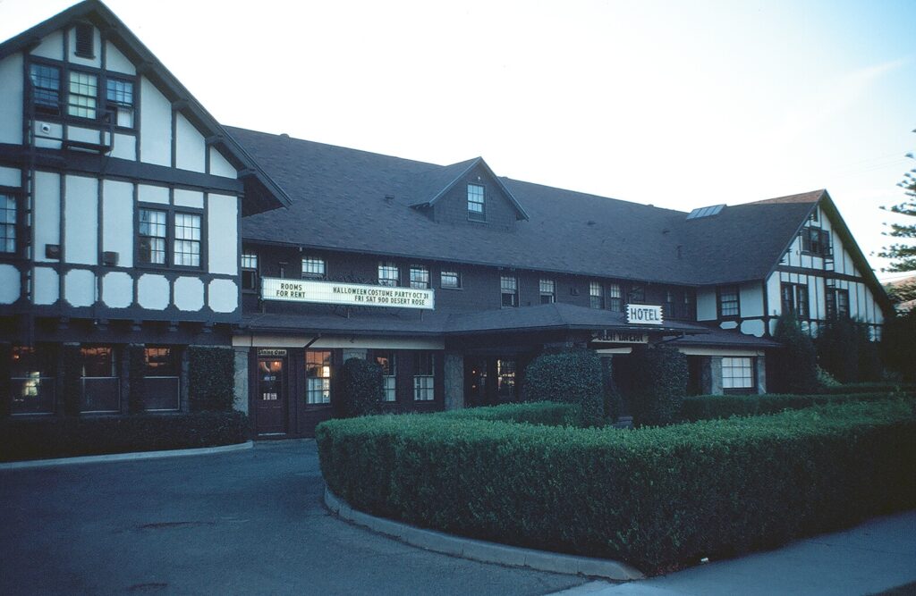 Glen Tavern Hotel exterior from 1981, Tudor-style building with white and dark brown facade. Sign displays "ROOMS FOR RENT" and "HALLOWEEN COSTUME PARTY OCT 31" above the entrance.