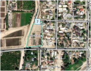 Map of a residential high density parcel in Piru, labeled 7 with RHD-20 du/ac zoning, bordered by Camulos St, adjacent to green agricultural fields.