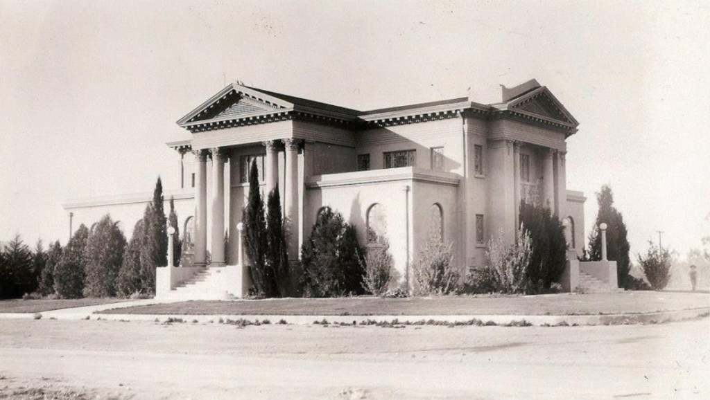 Black-and-white historical photograph of a classical-style landmark building with columns, triangular pediments, and landscaped grounds. Undated, credited to Simi Valley Historical Society & Museum.