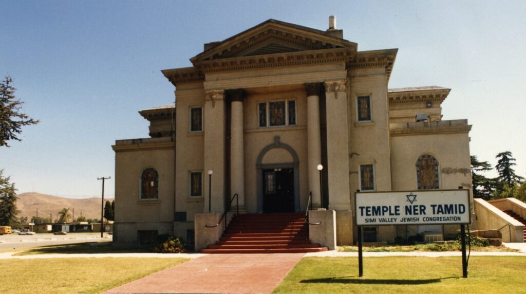 Temple Ner Tamid synagogue building, circa 1985, features classical columns, a red staircase, and a sign reading "TEMPLE NER TAMID SIMI VALLEY JEWISH CONGREGATION" with a Star of David emblem.