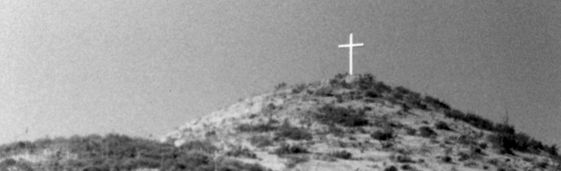 Black-and-white photograph of Mt. McCoy in Simi Valley, featuring a cross on the hilltop, circa 1980s.