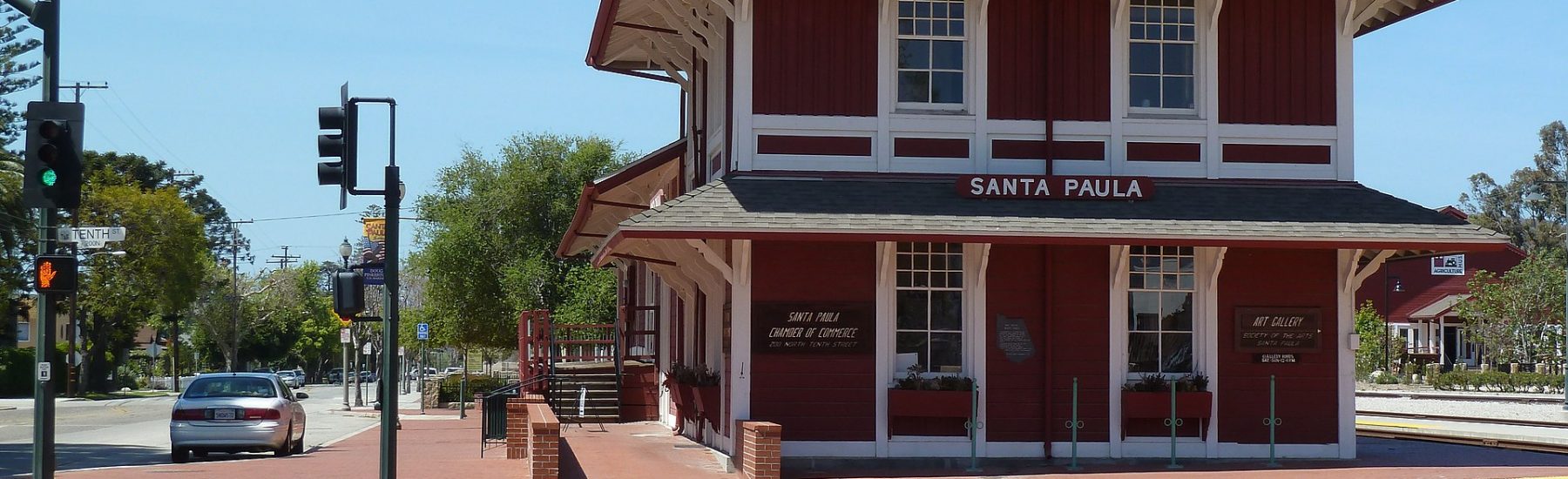 Santa Paula’s Southern Pacific Railroad Depot in 2012, a red and white two-story Victorian-style wooden building with surrounding streetscape.