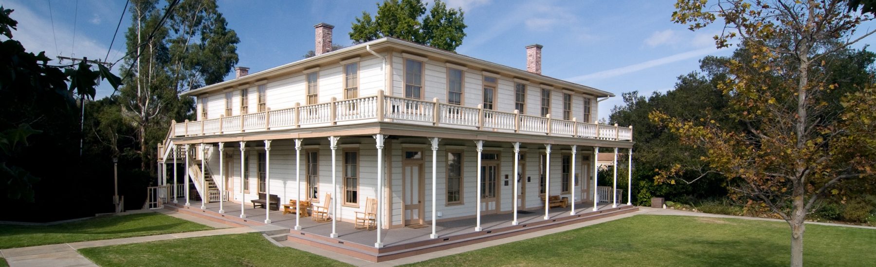 Stagecoach Inn with two-story Monterey-style architecture and wraparound porch, surrounded by green lawn, 2009.